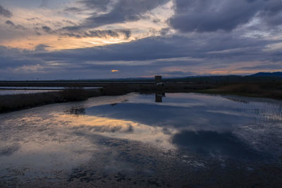Sunset over saltpans with reflection