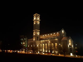 Illuminated city against sky at night