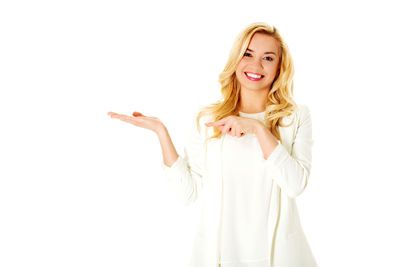 Portrait of a smiling young woman over white background