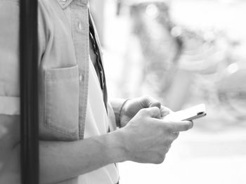 Midsection of woman using mobile phone