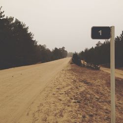 Empty road along trees