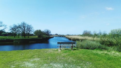 Scenic view of lake against clear blue sky