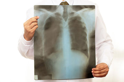 Midsection of man holding heart shape against white background