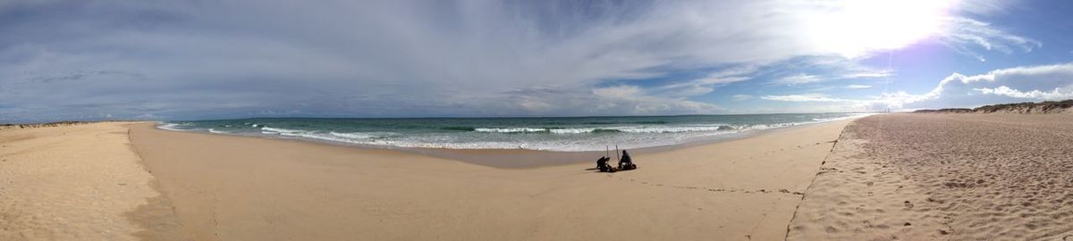 Panoramic view of beach against cloudy sky