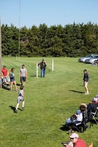 People playing soccer on golf course against sky