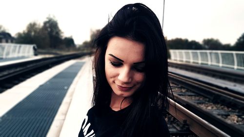 Beautiful young woman on railroad tracks