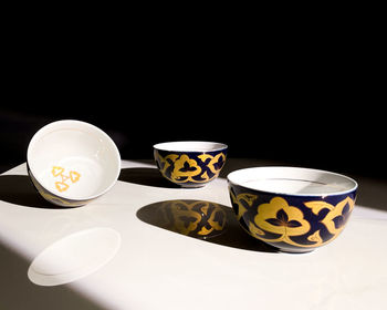 High angle view of coffee cup on table against black background
