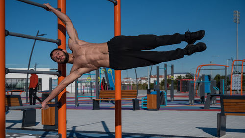 Low angle view of man exercising on street