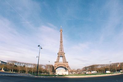Communications tower in city against sky