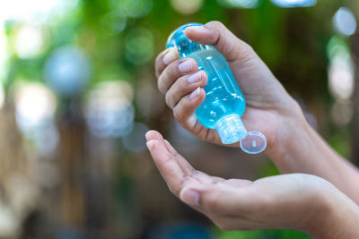 Close-up of person hand holding bottle