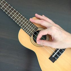 Cropped image of man playing guitar
