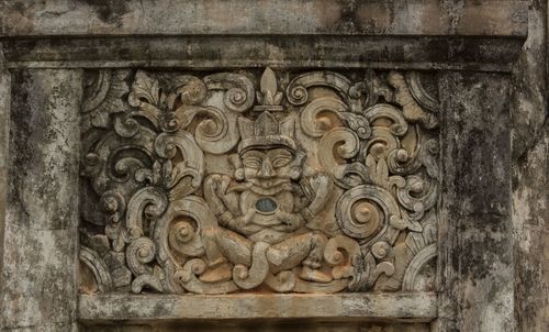 Close-up of carvings on brick wall