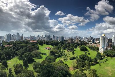 Panoramic view of trees and buildings against sky