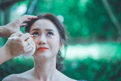 Portrait of a beautiful young woman holding hands