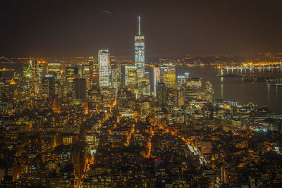 Illuminated cityscape against sky at night