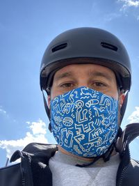 Portrait of man against blue sky