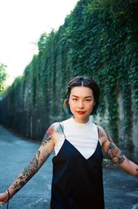Portrait of a young woman with tattoo