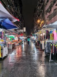 Illuminated city street during rainy season at night