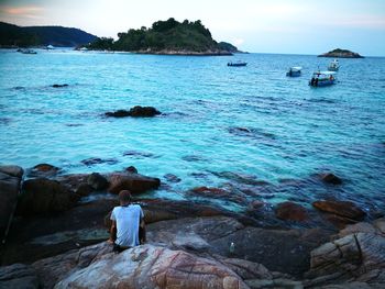 Rear view of woman looking at sea against sky