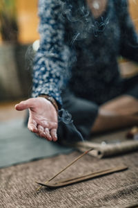 Woman meditating while exercising at home