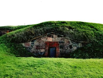 Built structure on field against sky