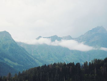 Scenic view of mountains against cloudy sky