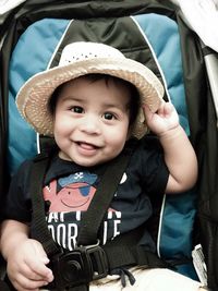 Portrait of cute boy sitting in car