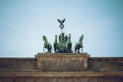 Low angle view of statue against blue sky