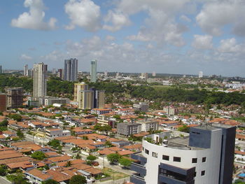 Cityscape against cloudy sky