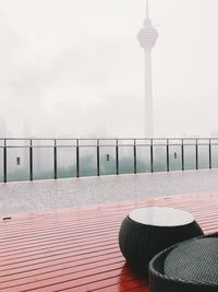 View of tower by building against sky
