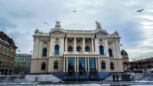 Low angle view of building against cloudy sky