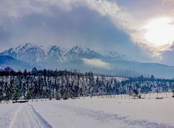 Scenic view of snow covered mountains against sky