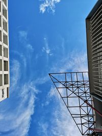 Low angle view of modern building against blue sky