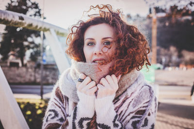 Portrait of young woman in warm clothing outdoors