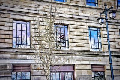 Man working on window of building