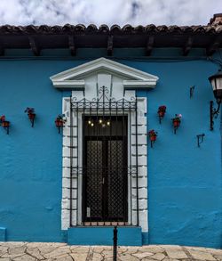 Closed door of building against blue sky