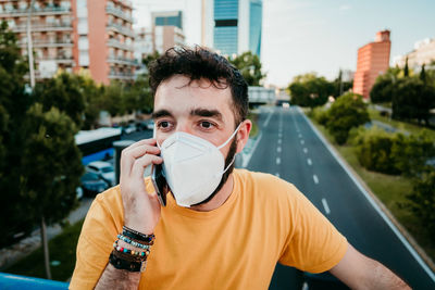 Portrait of young man in city