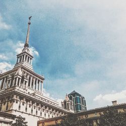 Low angle view of building against cloudy sky