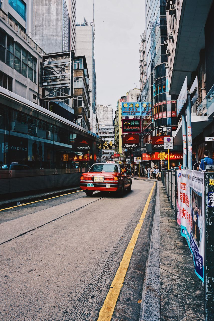 architecture, transportation, building exterior, city, built structure, street, public transportation, mode of transport, outdoors, road, day, no people, sky