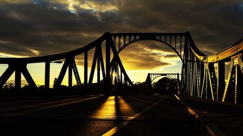 View of suspension bridge against cloudy sky