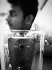 Close-up portrait of boy holding glass