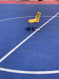 High angle view of empty chair on street