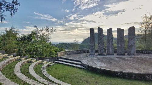 Built structure by trees against sky