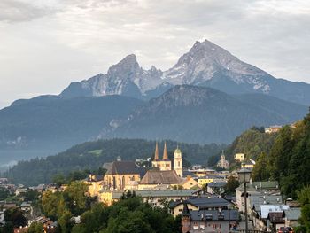 Panoramic view of buildings and mountains against sky