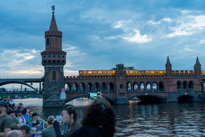 Group of people in front of bridge