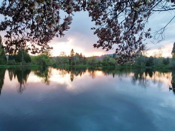 Scenic view of lake against sky at sunset