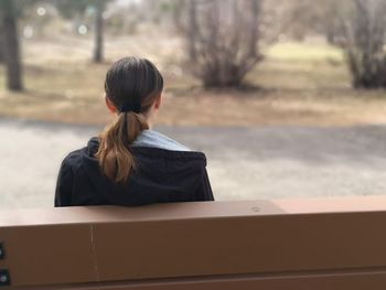 Rear view of woman standing in bus