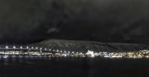 Scenic view of lake against sky at night