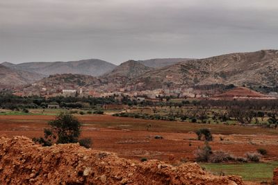 Scenic view of field and mountains against sky