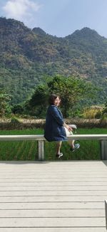 Rear view of man walking on road